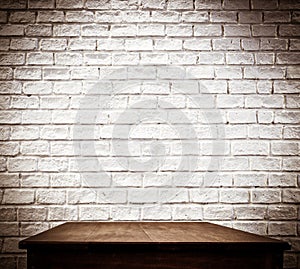 White brick wall and wooden table