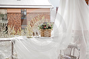 white bridal shoes and flowers in the basket