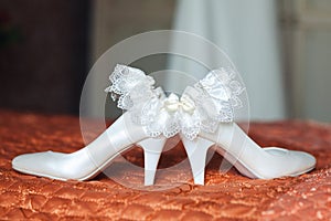 White brides shoes and garter photo
