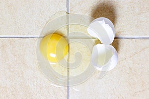 White broken egg on the kitchen floor tile