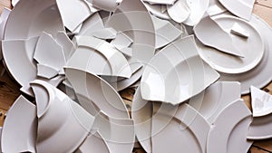 White broken plates on a wooden floor photo