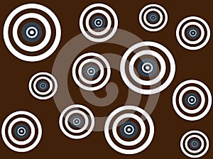 White, brown and blue targets on brown background