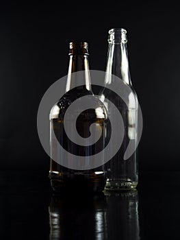 White and brown bottles on black background.