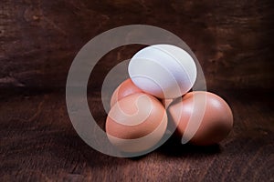 White and brown chicken eggs in a plastic package.