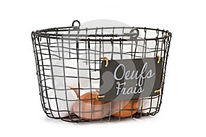 White and brown eggs in a wire basket