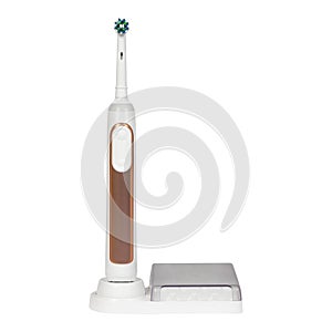 White with brown electronic toothbrush on a charge stand or tips container