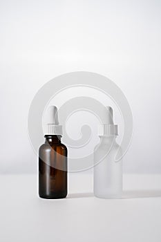 white and brown face serum bottles