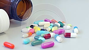 White and Brown glass medicine bottles with colorful tablets, pills, capsules drugs using for treatment and cure the disease.