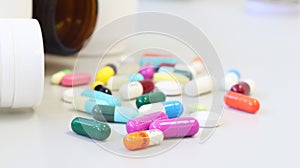 White and Brown glass medicine bottles with colorful tablets, pills, capsules drugs using for treatment and cure the disease.