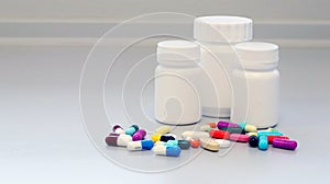 White and Brown glass medicine bottles with colorful tablets, pills, capsules drugs using for treatment and cure the disease.