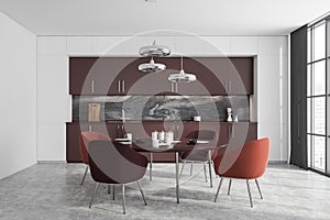 White and brown kitchen interior with dining table