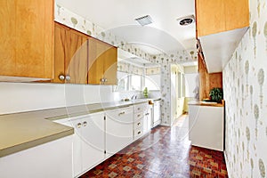 White and brown kitchen interior with tile and floral patterned