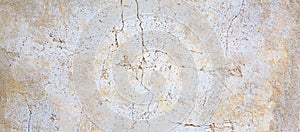 White and brown rough grained stone or concrete stucco wall, texture background