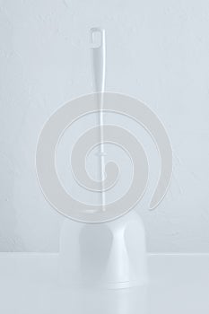 White brush brush for cleaning toilet bowl on a stand. White background