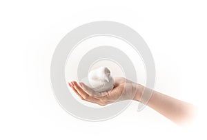 White bubbled foam in woman`s nice hand