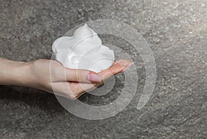 White bubbled foam in woman`s nice hand