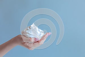 White bubbled foam in woman`s nice hand