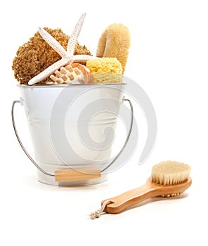 White bucket filled with sponges and scrub brushes