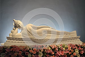 White Buddha Beautiful statue sleep on the flower photo