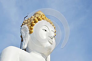 White Buddha image in Wat Phrathat Doi Kham ancient temple in Thailand