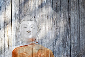 White buddha immage on wood background