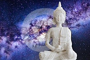 White buddha in restful position with the entire universe in the background