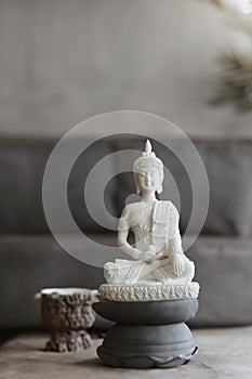 White Buddha statue in a contemporary home with neutral colors