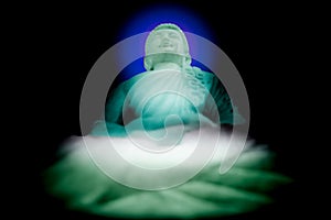 White Buddha statue with dark background