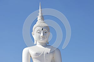 White Buddha statue with emerald on the forehead.