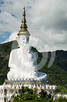 White buddha statue with mountain