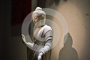 White Buddha statue in a museum.