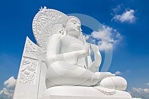 White buddha status on blue sky background
