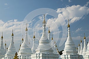 White Buddhist stupas in Sanda Muni Pagoda, Mandalay, Myanmar