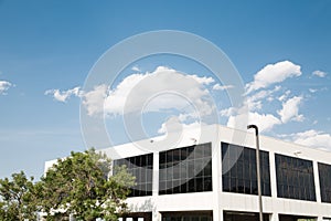 White Building with Black Windows Under Blue Sky