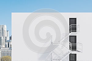 White building with fire escape ladder, city