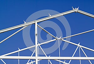 White building frame against blue sky