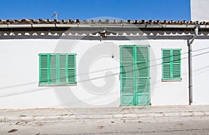 White building with green shutters in El Terreno photo