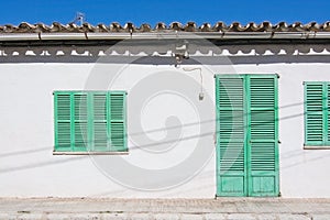 White building with green shutters in El Terreno photo