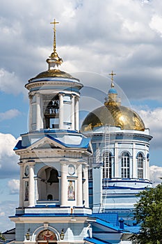 White building of Pokrovsky Cathedral with blue roof and golden domes. Temple of Voronezh Diocese of Russian Orthodox Church.