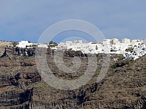 White buildings lining the caldera crater walls photo