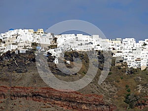 White buildings lining the caldera crater walls photo