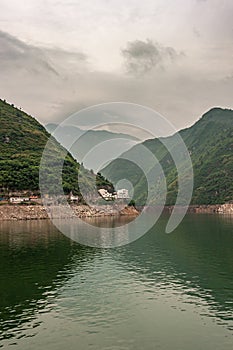 White buildings on tall green mountains, Wu Gorge, Guandukou, China