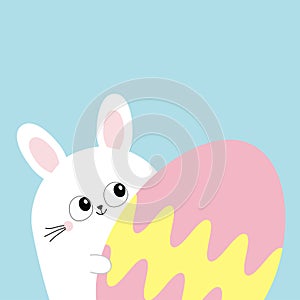 White bunny rabbit holding big painted egg. Happy Easter. Funny head face, eyes, ears. Cute kawaii cartoon character. Baby greetin