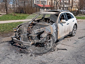 White Burned car at the edge of the road