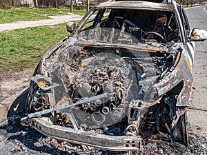 White Burned car at the edge of the road