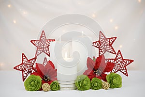 White burning Christmas candles background with white lights and red stars