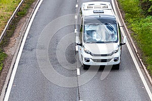 White bus coach on uk motorway in fast motion