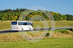 White bus on the road in the countryside