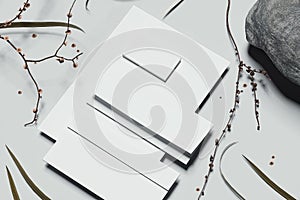 White business stationery mock-up with stone and tree branches on. 3D rendering.