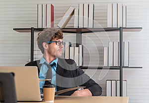 White Businessman looking out the windows with worrying face on office desk with copy space